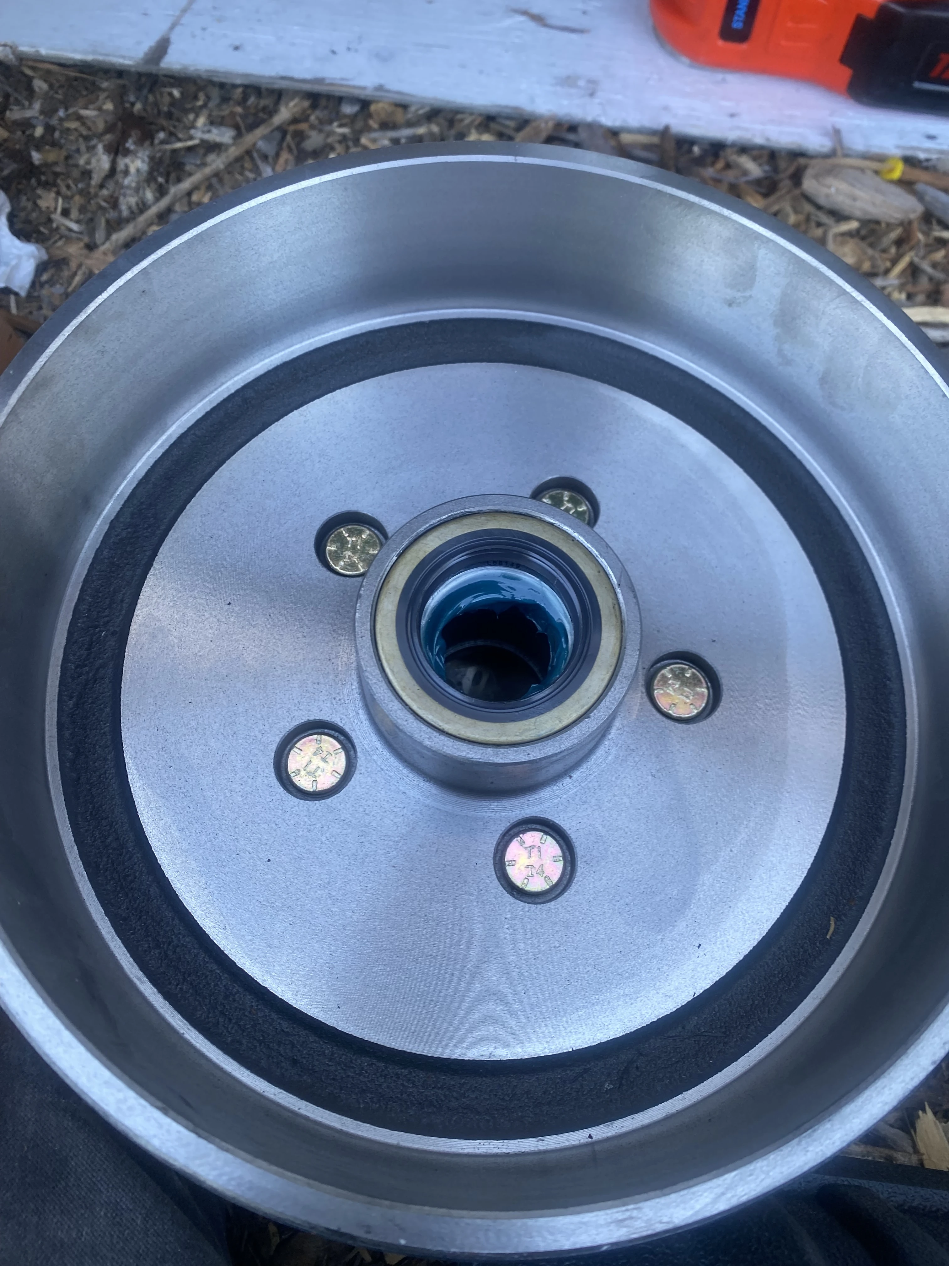 Trailer hub and brake drum with a greased bearing seal